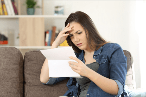 Concerned woman reading a letter